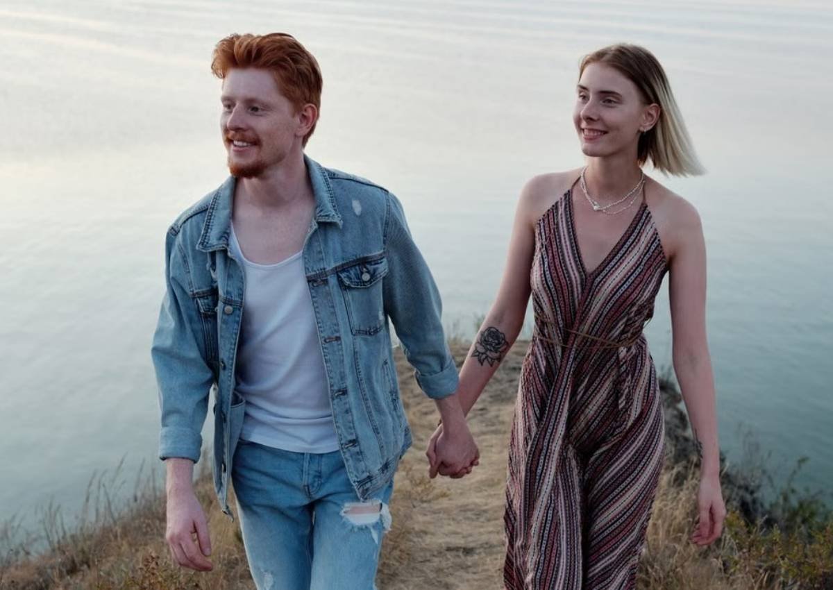 happy couple holding hands hiking cliff over sea natural vitality intimacy energy